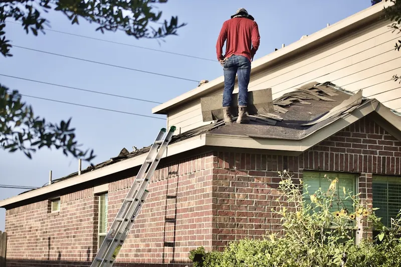 Professional roofer working on a residential roof in Center World